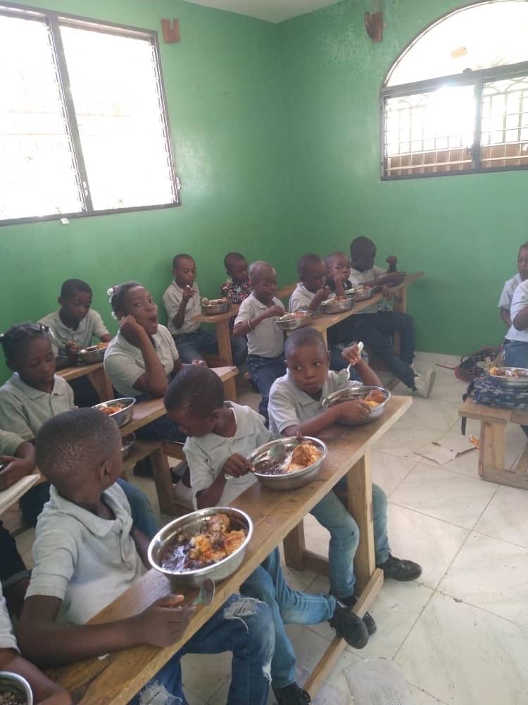 Students eating a meal together in a classroom